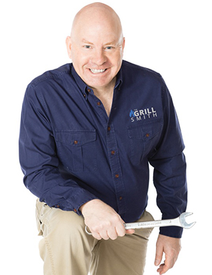 A smiling professional contractor man in navy uniform holding wrench on hands
